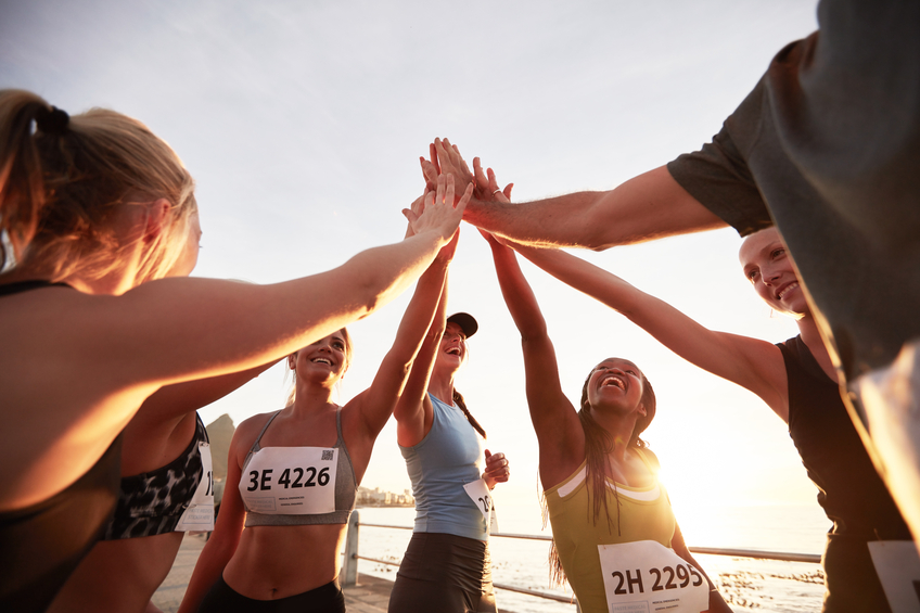 Runners High-Fiving After a Race